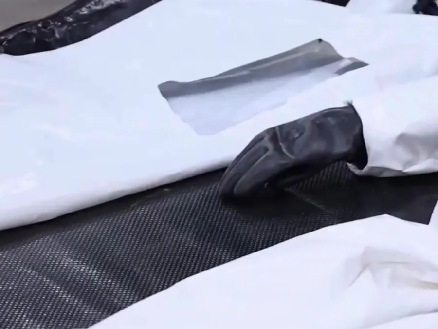 Close-up of the suit laid flat, showing the glove and a valve fitting